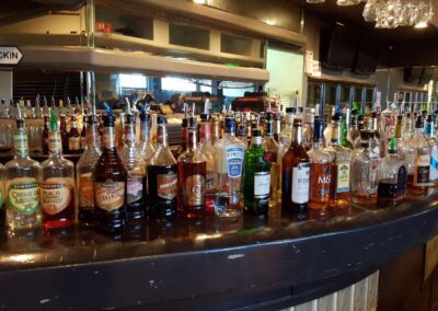group of bottles of alcohol on a bar