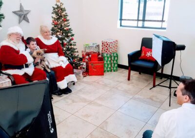 Person and child sitting in a chair with a charismas tree